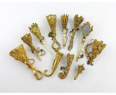 λ A collection of ten 19th century gilt-metal posy holders, various designs, some with ivory and mother-of-pearl handles, one