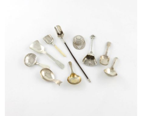 λ A collection of ten silver caddy spoons, various dates and makers, including ones of shovel form, a modern jockey cap, and 