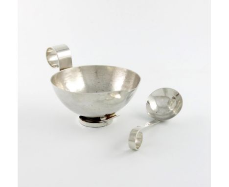 Designed by Michael Newberry, a modern metalware sauce boat and ladle, unmarked, circular tapering form, scroll handle, spot-