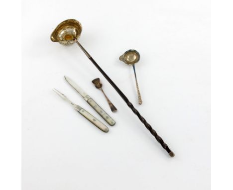 λ A mixed lot of silver flatware, comprising: a toddy ladle, the bowl set with a coin, twisted whale-bone handle, a folding f