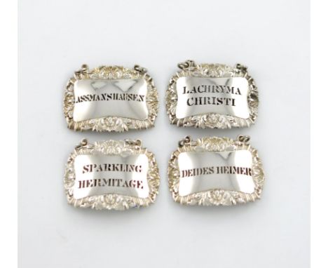 A set of four Victorian silver wine labels, by The Barnards, London 1843, rectangular form, foliate scroll and shell borders,