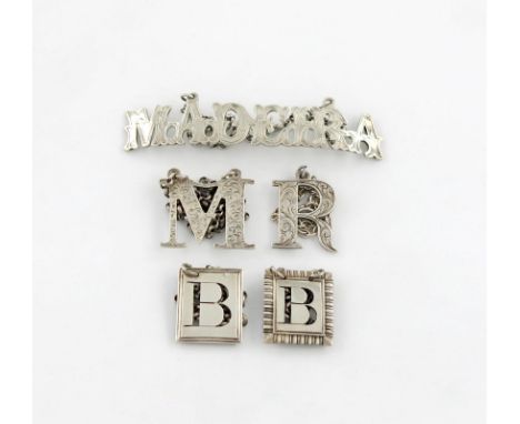 A collection of five 19th century silver 'cut-out letter' wine labels, various dates and makers, comprising: 'MADEIRA', 'R', 