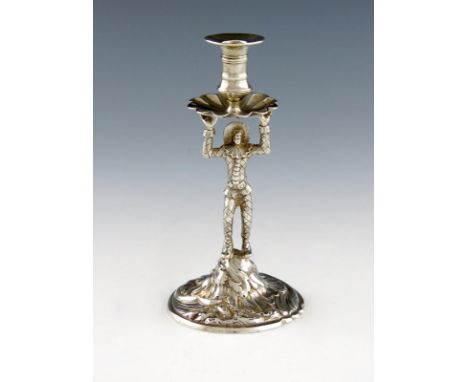 An unmarked silver harlequin taper stick, probably 18th century, modelled in a standing position, with raised arms holding a 