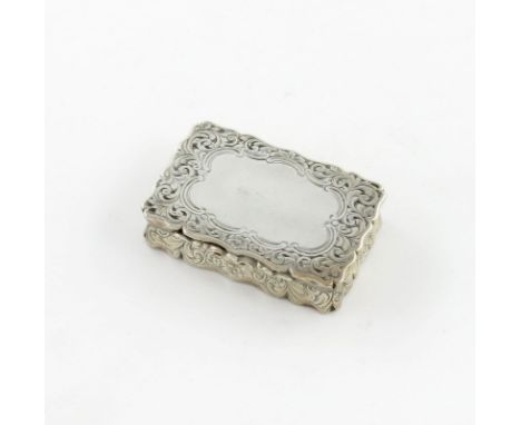 A Victorian silver snuff box, by E. Smith, Birmingham 1857, rectangular form, engraved foliate scroll decoration, the hinged 