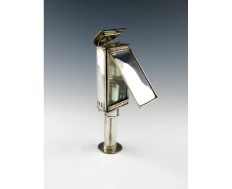 A Victorian electroplated student's lamp, rectangular form, semi-circular back, hinged cover, engraved with a crest, height 2