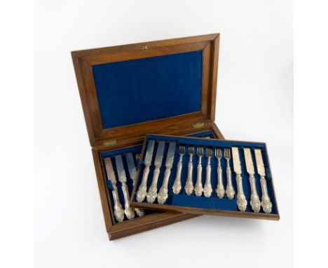 A set of eighteen Victorian silver fruit knives and forks, by Henry Wilkinson and Co, Sheffield 1856, with foliate handles, t