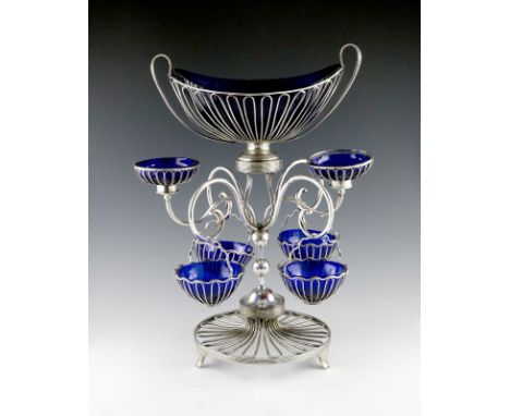 A George III old Sheffield epergne, unmarked circa 1790, central oval wirework basket, with four scroll arms each holding a w