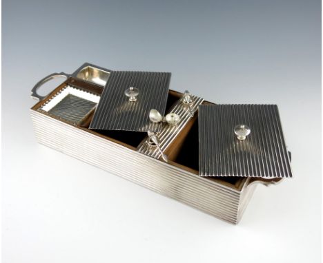 An electroplated two-handled smoking compendium, rectangular form, fluted decoration, side handles, including four ashtrays, 