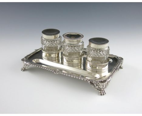 A George IV silver inkstand, by Joseph Angell, London 1821, rectangular form, shell and gadroon border, with two pen wells, c