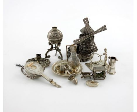 A collection of miniature silver items, comprising: a filigree windmill, a mandolin, a chamber stick, a figure of a boy and a