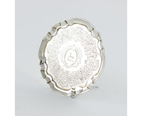 A George III silver waiter, possibly by Edward Cornock, London 1731, circular form, moulded border, chased decoration, engrav
