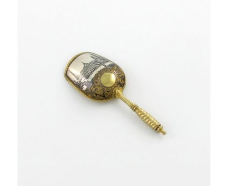 A Russian silver-gilt and niello work caddy spoon, Moscow 1880, maker's mark B.C, shovel form, the reverse of the bowl with a