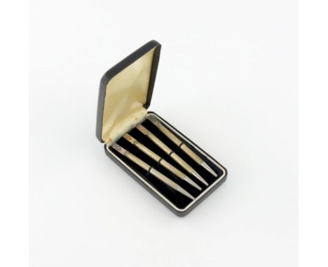 A set of four silver bridge pencils, engine-turned decoration, the terminals with a playing card suit, in a fitted case.