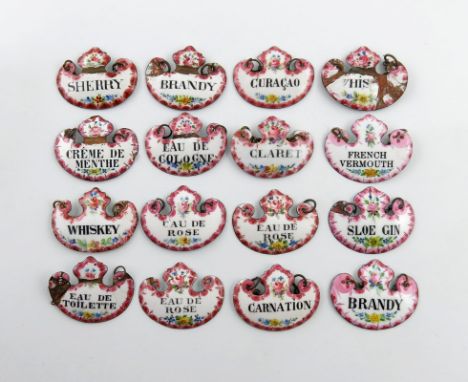 A collection of sixteen enamel wine and toilet labels, cartouche form, with black lettering on a white ground with a pink bor