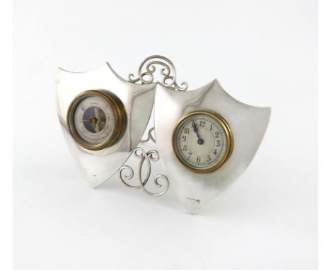A silver clock and barometer, maker's mark worn, London 1896 of double shield form, with scroll wire-work decoration, pierced