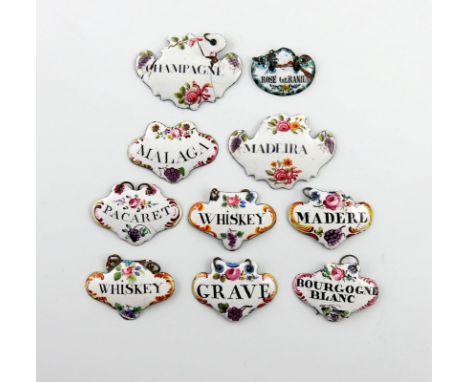 A collection of ten enamel wine and toilet labels, cartouche and escutcheon form, with black lettering on a white ground deco