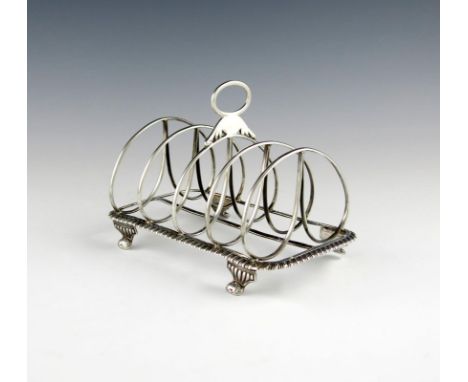 A George IV silver five-bar toast rack, by Emes and Barnard, London 1821, rectangular form, gadroon border, central oval carr