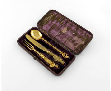 A Victorian three-piece electro-gilded knife, fork and spoon set, retailed by Elkington, the knife and fork with figural term