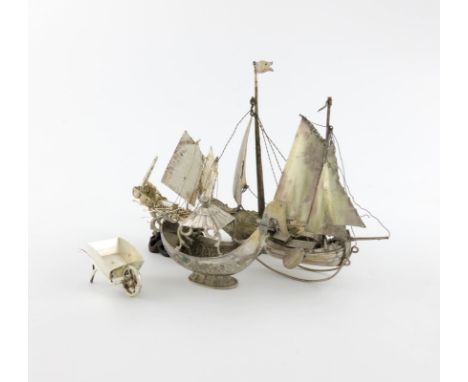 A mixed lot of silver miniatures, comprising a sailing boat, with import marks for London 1900, importer's mark of William Mo