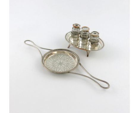 A George III old Sheffield plated two-handled lemon strainer, circa 1780-90, the shallow circular bowl with a beaded border, 