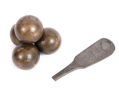 19TH CENTURY - CRIMEA - A STACK OF FOUR BRASS GRAPESHOT  formed as a paperweight; together with a Crimean relic spoon handle 