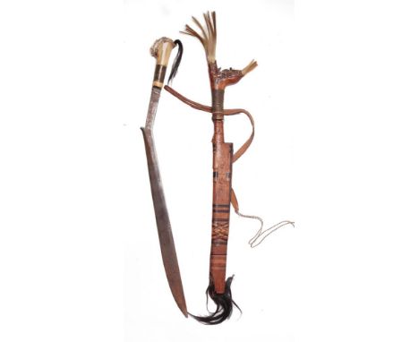 EDGED WEAPONS - A DYAK HEADHUNTER'S SWORD MANDAU  of traditional form and construction, with a bone and monkey hair carved gr