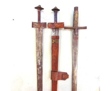 EDGED WEAPONS - THREE TUAREG TAKOUBAS OF OMDURMAN TYPE  19th century, of traditional form and construction, one with a leathe
