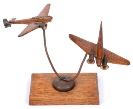 SECOND WORLD WAR - AN ITALIAN PRISONER OF WAR MODEL  of two carved oak twin-engined bombers, with perspex propellers, on bras