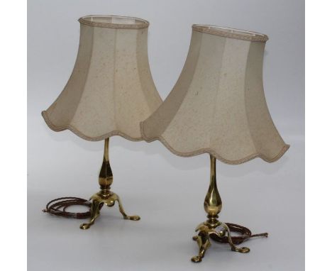 A pair of brass table lamps, eachwith waisted hexagonal column, domed base and three downswept feet. Height including shade, 