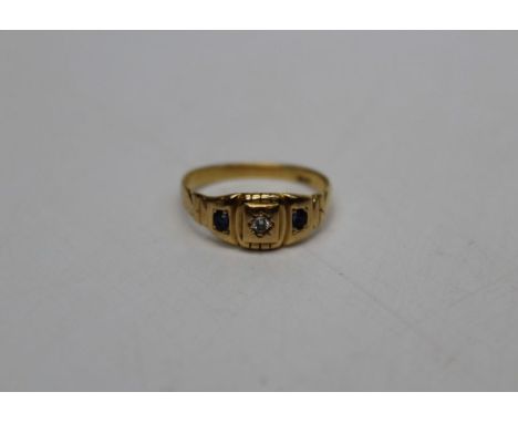 A three stone yellow metal sapphire and diamond panel ring. Early 20th century three stone ring, stamped "18ct". Size R. Appr