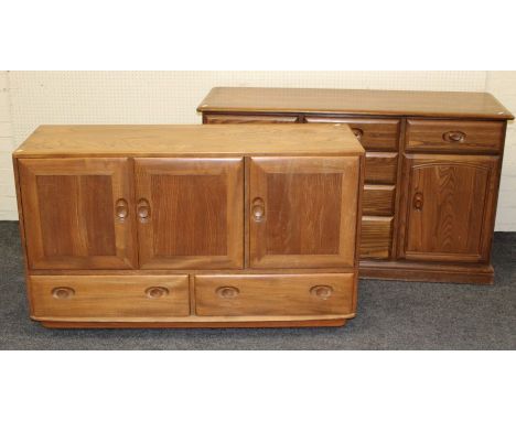 An Ercol light elm sideboard, the rectangular top over three cupboard doors and a pair of drawers, on plinth and castors, 76 