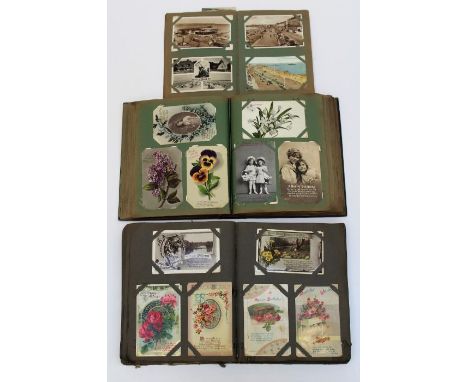 Postcards, three early 20th century albums containing many dozens of cards including humorous, photographic portrait, topogra