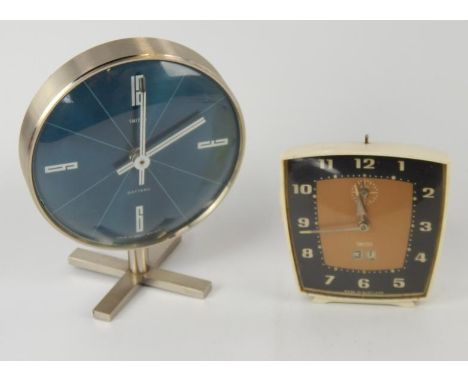 Two mid 20thC mantel clocks by Smiths, one having circular sunburst dial with Arabic numerals, the other of flared rectangula