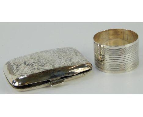 A George V silver pocket cigarette case, engraved with scrolls and a monogram R S, Birmingham 1924, and a silver napkin ring 