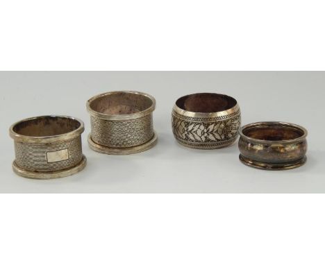 A pair of silver napkin rings, with engine turned decoration, and two other silver napkin rings, 2oz.