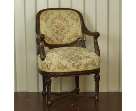 A 19thC French carved walnut fauteuil, with tapestry upholstery and carved with acanthus and stylised guilloche decoration.