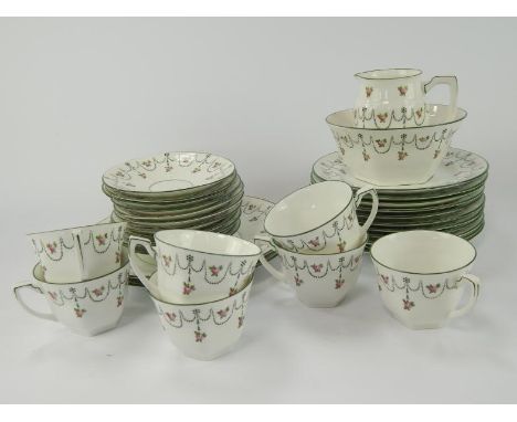 A Foley China tea service, with rosebud and swag decoration, comprising 7 tea cups and 11 saucers, two bread and butter plate