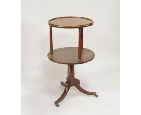   A Regency style mahogany serving buffet, with two circular platforms, turned pedestal and three sabre legs with brass casto