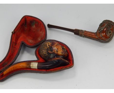 A Meerschaum briar pipe, in the form of a Negro head with amber mouthpiece, with one other briar pipe, (2), (AF).