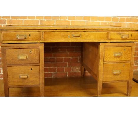 A light oak pedestal desk, 152cm x 92cm.