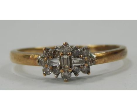 A 9ct gold dress ring, with three baguette cut white stones surrounded by eleven others, 2g.all in