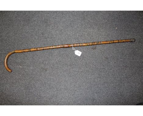 A FOLK ART WALKING STICK,  decorated all over with painted scenes, figures and animals, L 94 cm