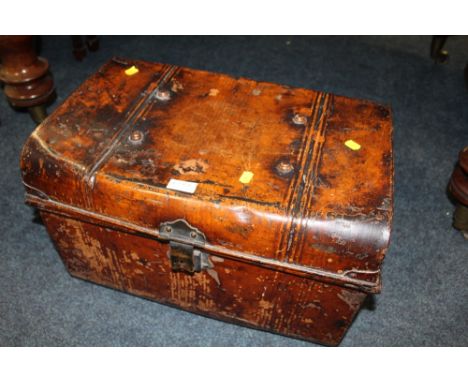 A BROWN TIN TRUNK