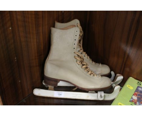 A VINTAGE PAIR OF GOOD QUALITY ICE SKATES RETAILED BY LILLYWHITES OF PICCADILLY CIRCUS
