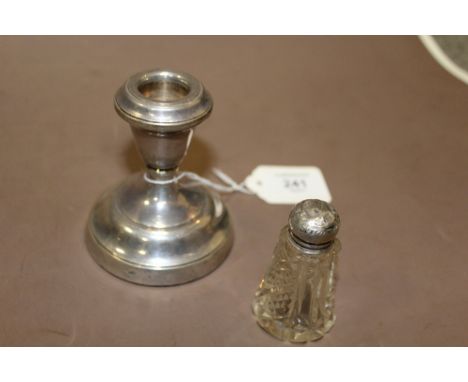 A HALLMARK SILVER SQUAT CANDLE STICK TOGETHER WITH A HALLMARK TOPPED BOTTLE (2)