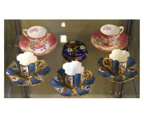 Three good quality Coalport cabinet cups and saucers, each decorated with alternate panels of birds, gilt handles, together w