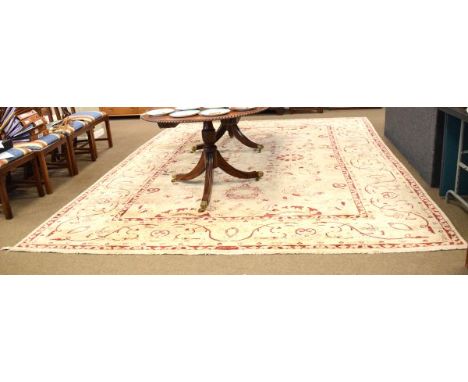 Middle Eastern style carpet having floral decoration on a mushroom ground within multi borders, 393cm x 305cm  