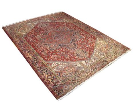 Middle Eastern wool carpet, the central field with geometric decoration on a red ground within multi borders, 345cm x 263cm  