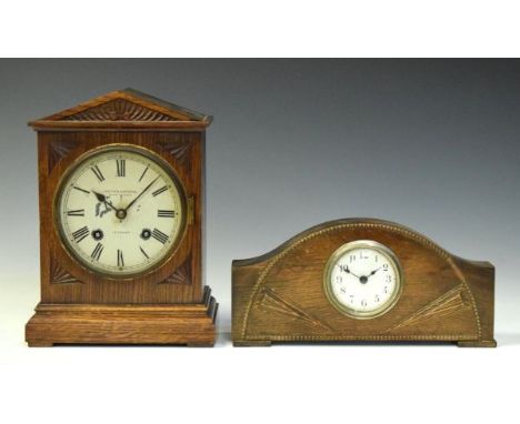 Two early 20th Century oak mantel clocks comprising: a German two-train example retailed by Curtis &amp; Horspool Leicester i