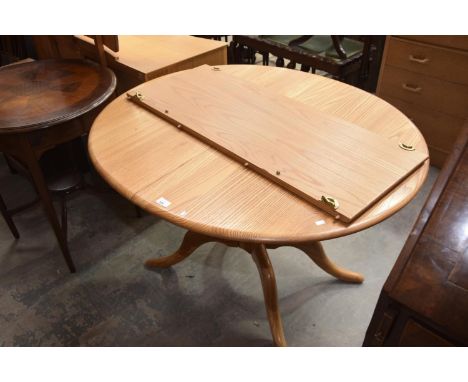 An Ercol light elm oval extending kitchen table.111cm extends to 150cmHeight 72cmWidth 98cm. 